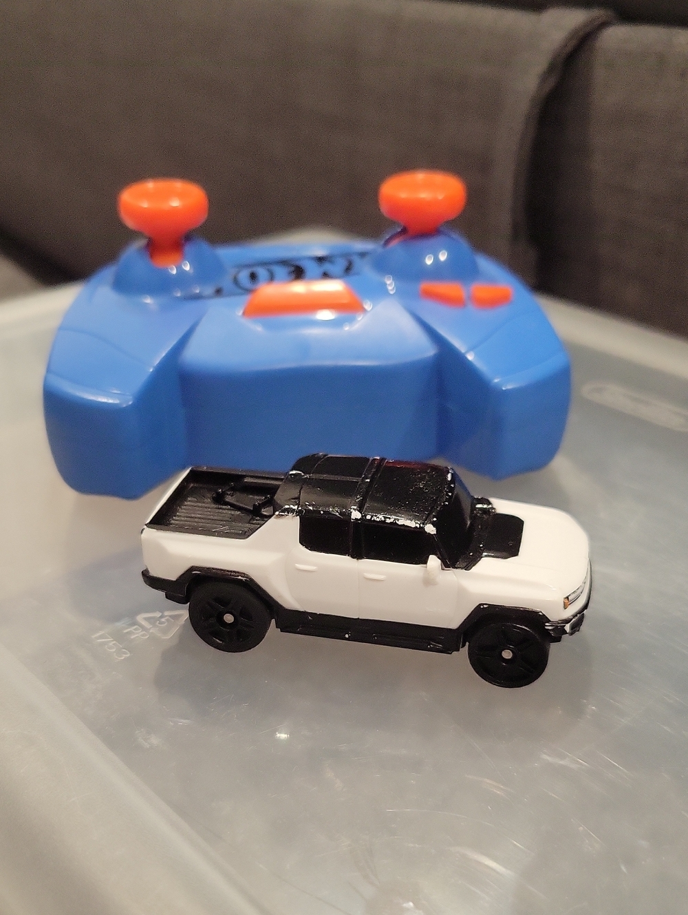 Blue and Orange Remote Controller with White and Black Toy Pickup Truck